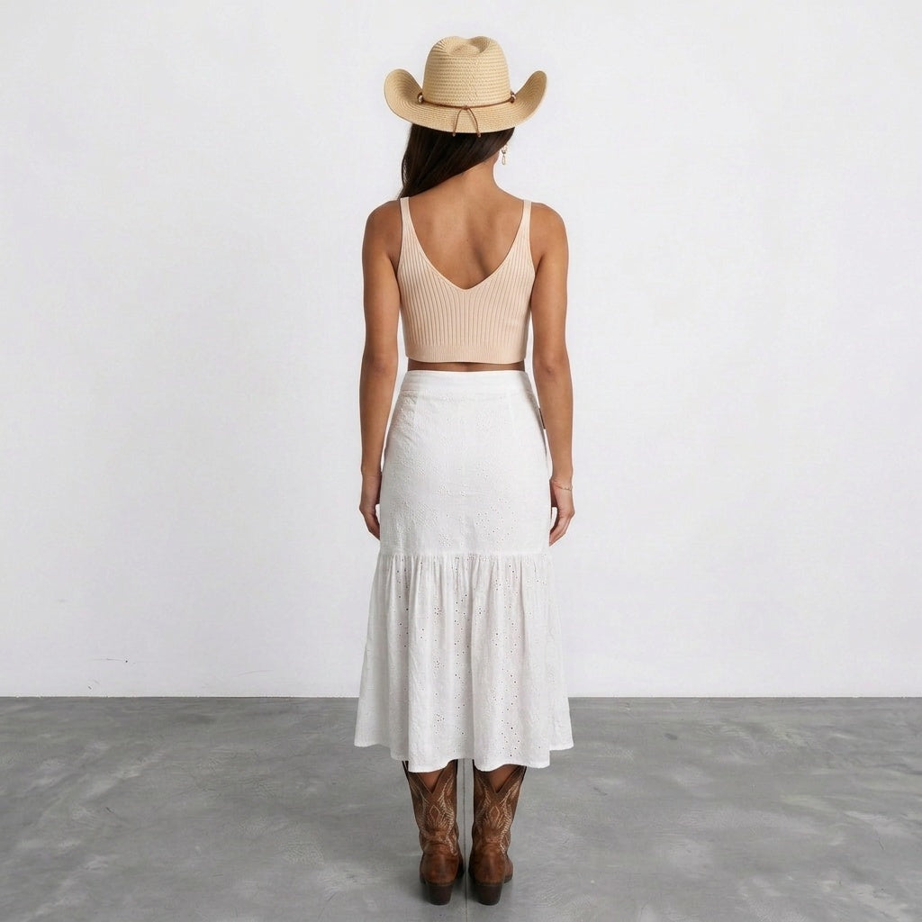 Image of Back view of a coastal cowgirl straw hat worn with a white tiered skirt