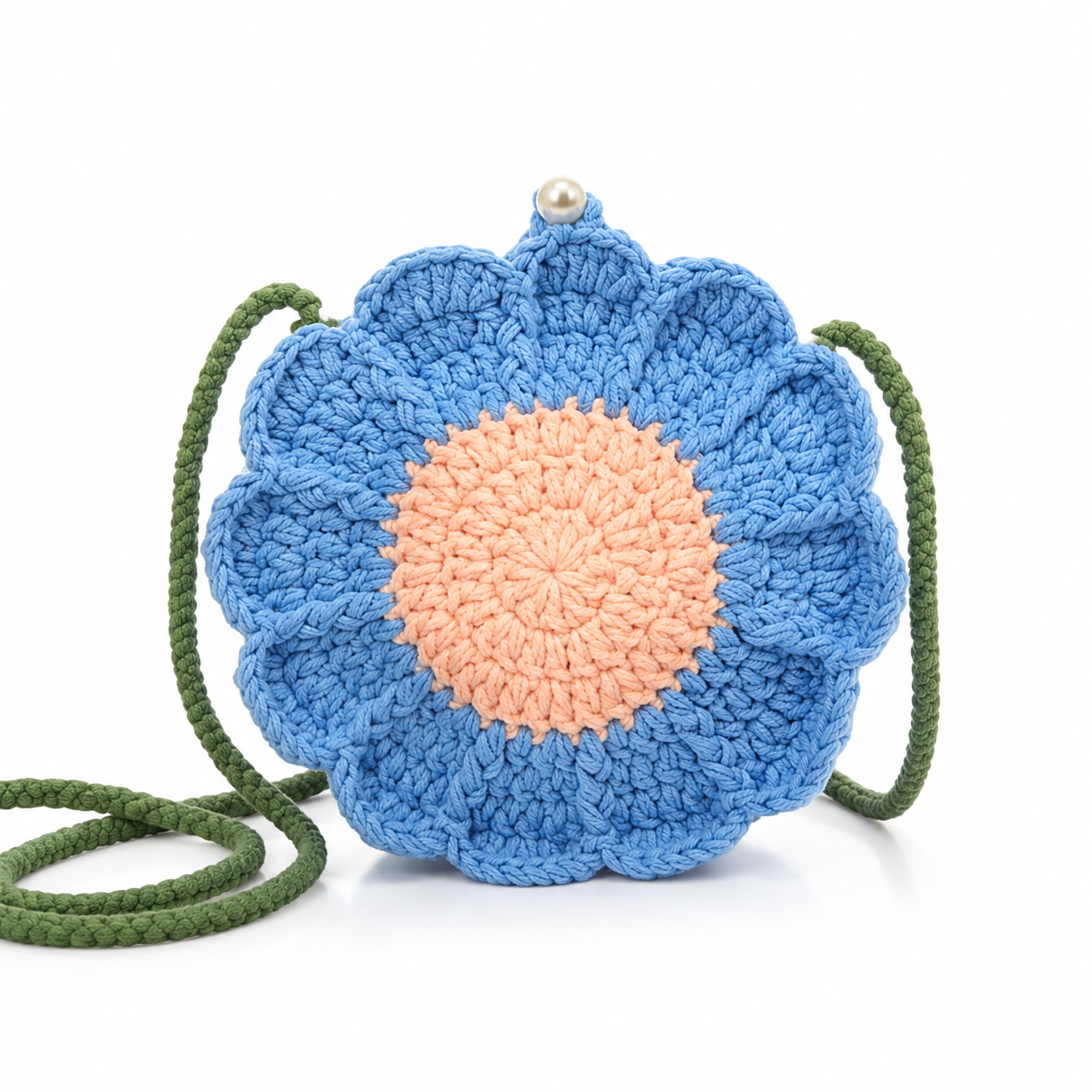 Image of A crochet bag in a flower-shaped light blue with a peach-pink center and an olive green braided strap, featuring a small pearl clasp at the top, shown on a white background.