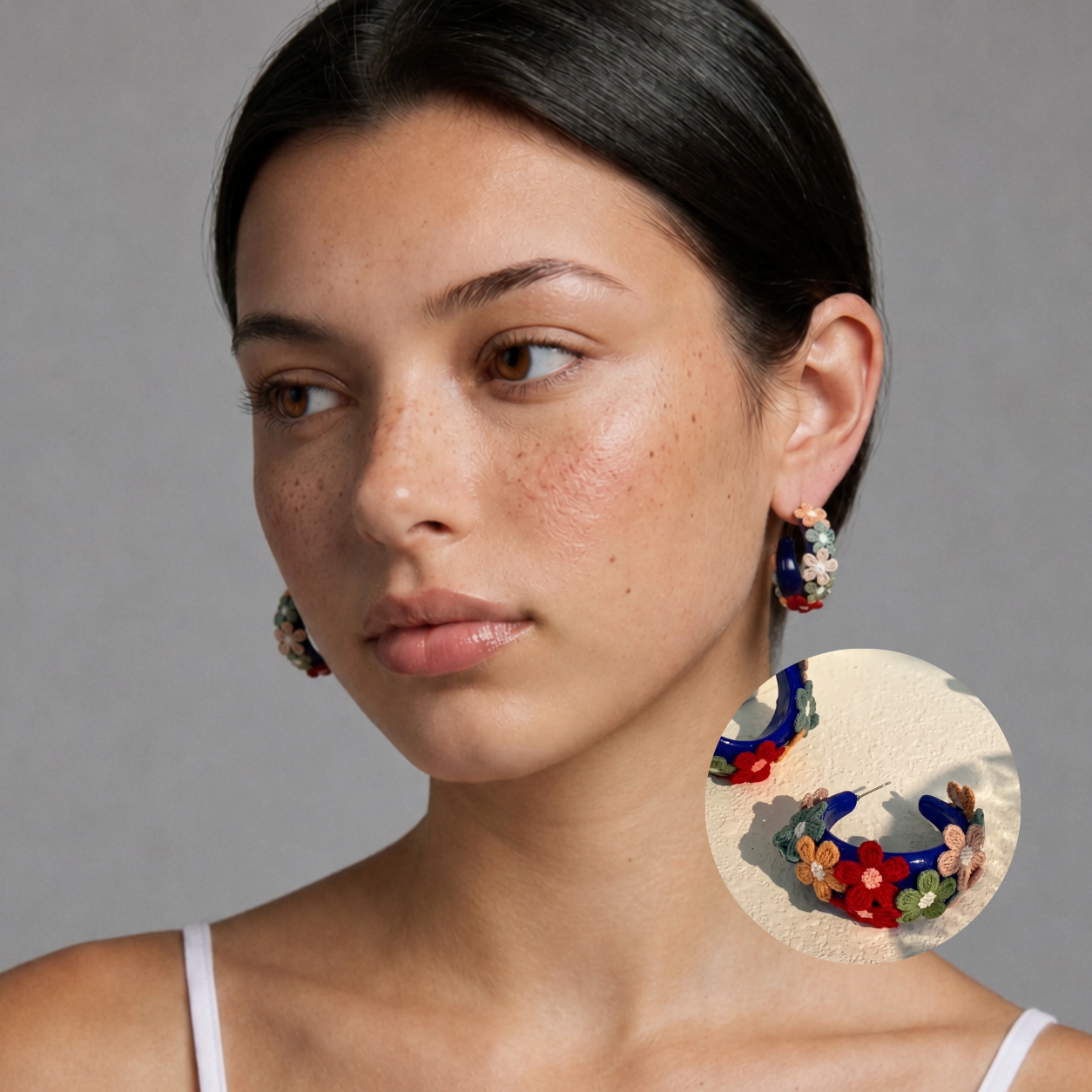 Image of Side view of woman wearing Midnight Blue embroidered daisy hoop earrings, head tilt, studio background