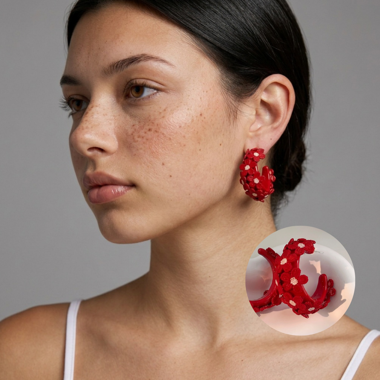 Image of Side view of woman wearing Crimson Red embroidered daisy hoop earrings, studio background