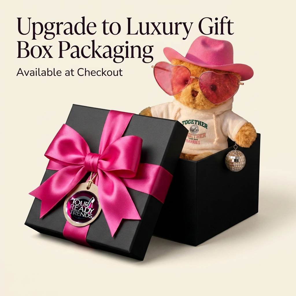 Image of A promotional graphic for a luxury gift box upgrade, showing an open black gift box with a large bright pink satin bow and a round charm that reads 'TOGETHER TOGETHER TOUR, HARRIES.' A teddy bear wearing a pink cowboy hat, pink heart-shaped sunglasses, and a cream hoodie sits inside the box.
