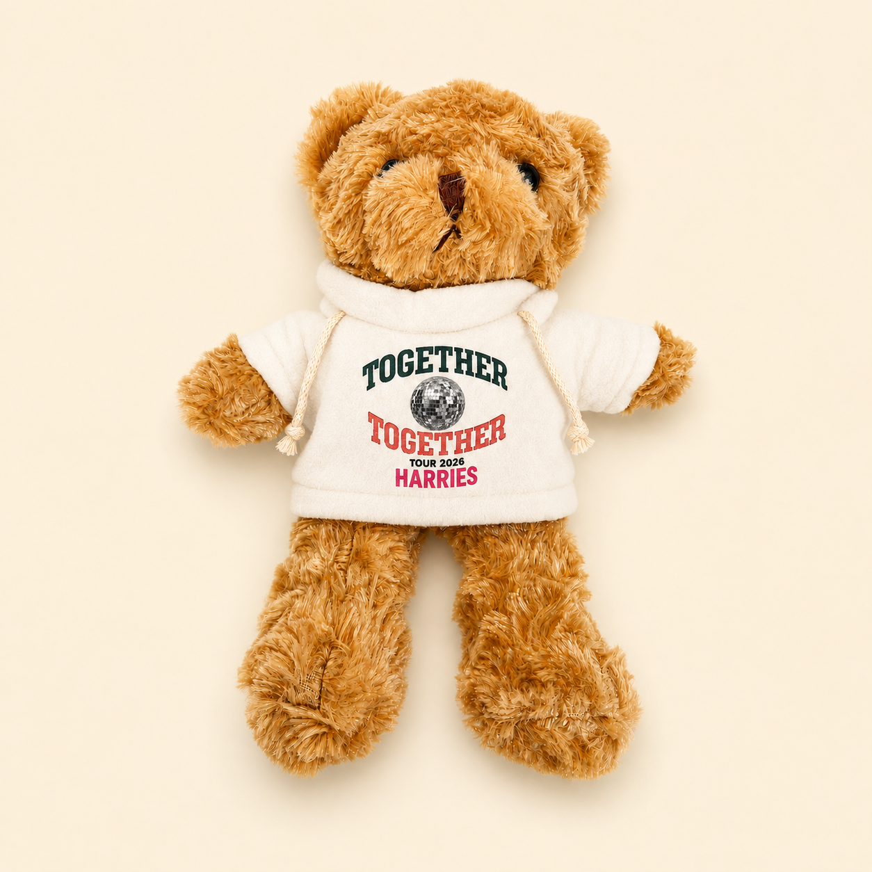 Image of A brown plush teddy bear wearing a small white hoodie with the words 'TOGETHER' and 'YOUR DOGS HARRIES' printed on the front, photographed on a plain light beige background.