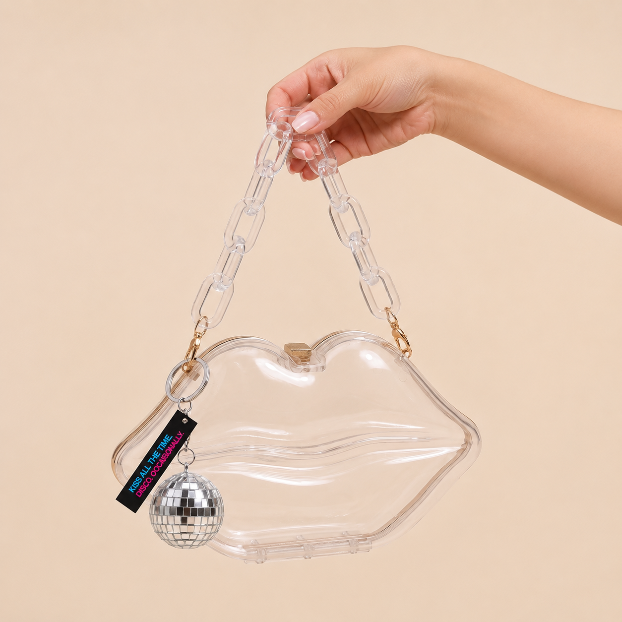 Image of Model holding clear Kiss Purse by interchangeable chain strap