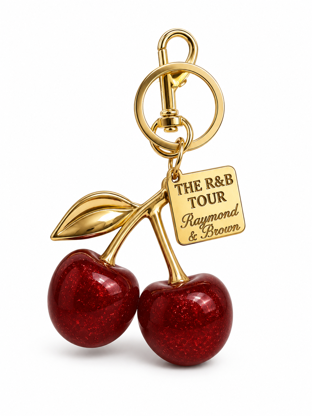 Image of Gold cherry bag charm keyring with red glitter cherries and R&B Tour Raymond and Brown engraved tag